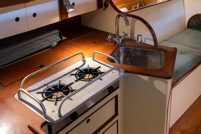 Slide: The Image of Interior of 2008 Custom Frank Paine Sloop with stove and sink in compact kitchen area. - 23