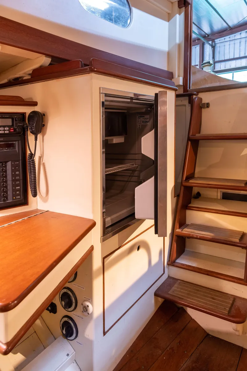Slide: The Image of Interior of 2008 Custom Frank Paine Sloop with wooden stairs and built-in appliances. - 25