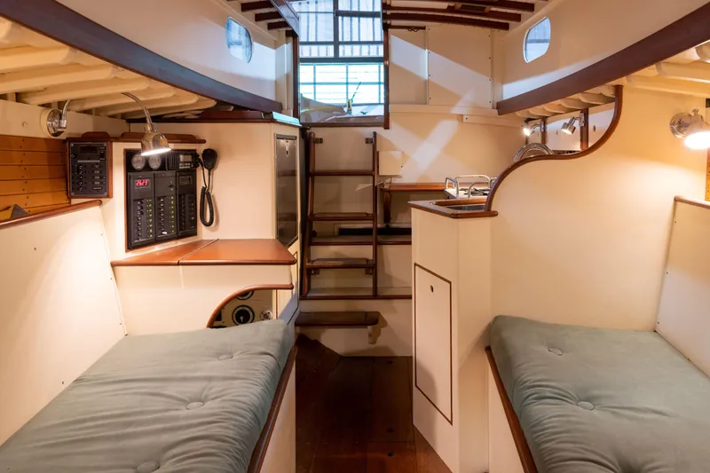 Slide: The Image of Interior of 2008 Custom Frank Paine Sloop with cozy bunks and wooden accents. - 26