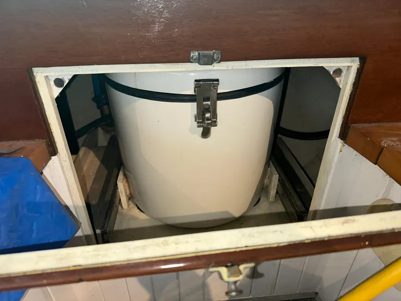 Slide: The Image of Storage compartment on a 2008 Custom Frank Paine Sloop, featuring a secured white container. - 35