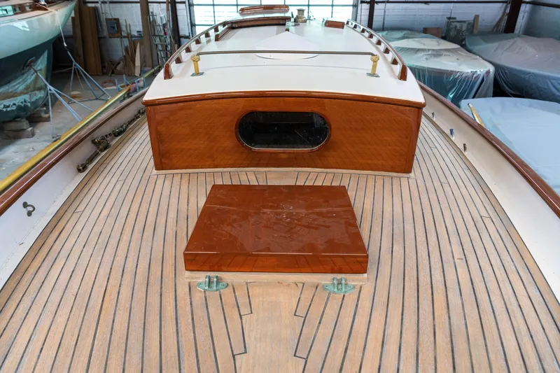 Slide: The Image of Custom 2008 Frank Paine Sloop with wooden deck and cabin, in a boatyard setting. - 45