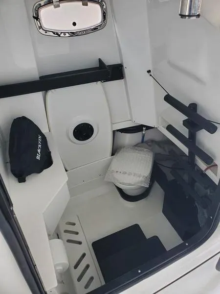 Slide: The Image of 2023 Blackfin 332cc boat interior cabin with seating and storage. - 7