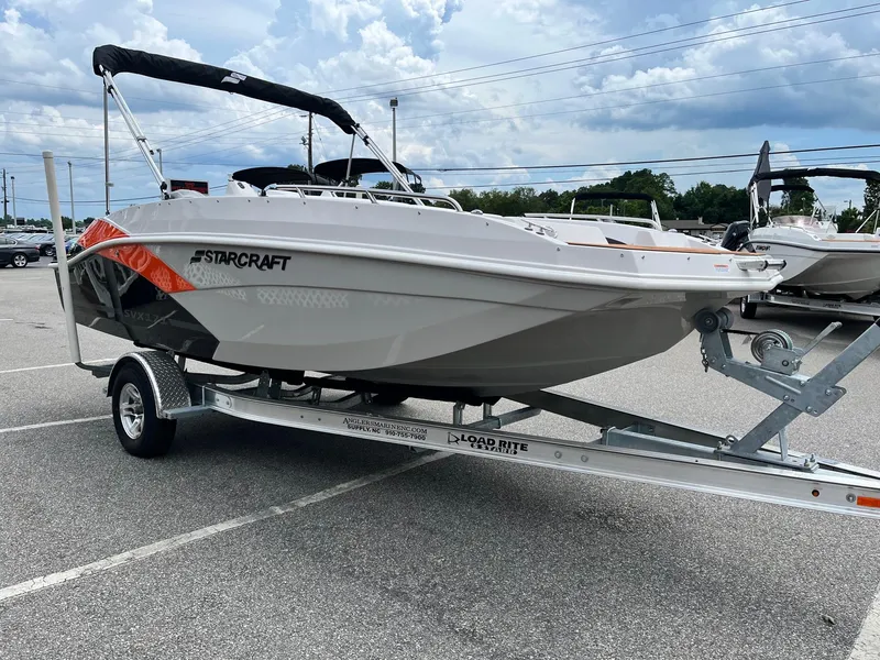 Slide: The Image of 2024 Starcraft SVX 171 boat on a trailer in a parking lot. - 1