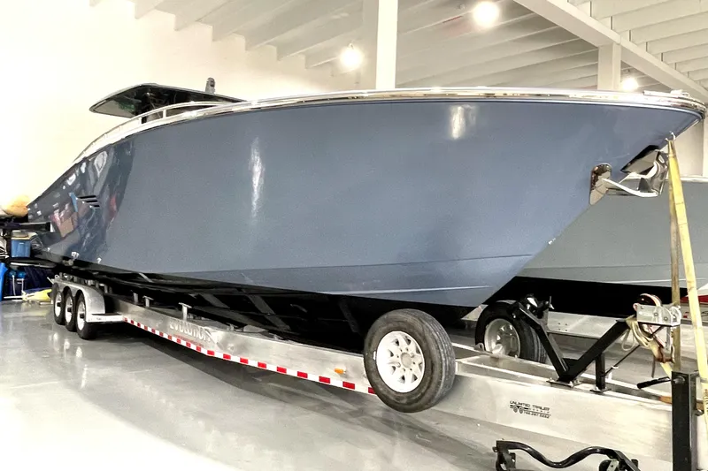 Slide: The Image of 2023 Canados 431 GLADIATOR boat on a trailer in a showroom. - 12