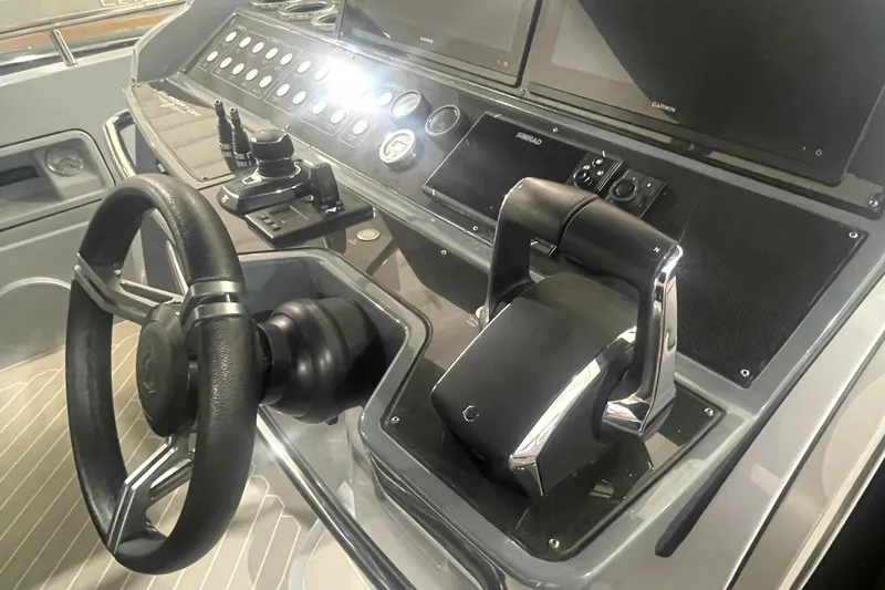 Slide: The Image of Control panel of 2023 Canados 431 Gladiator yacht with steering wheel and throttle. - 17