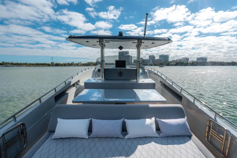 Slide: The Image of 2023 Canados 431 GLADIATOR yacht with sunbed and city skyline in the background. - 3