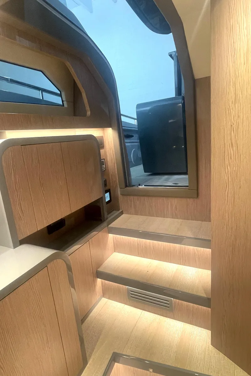 Slide: The Image of Interior of 2023 Canados 431 Gladiator yacht with modern wooden finish and illuminated steps. - 30