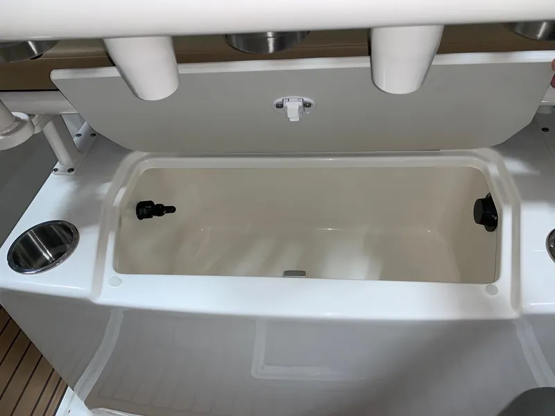 Slide: The Image of 2024 Bayliner Trophy 22CC boat livewell with rod holders and cup holders. - 16