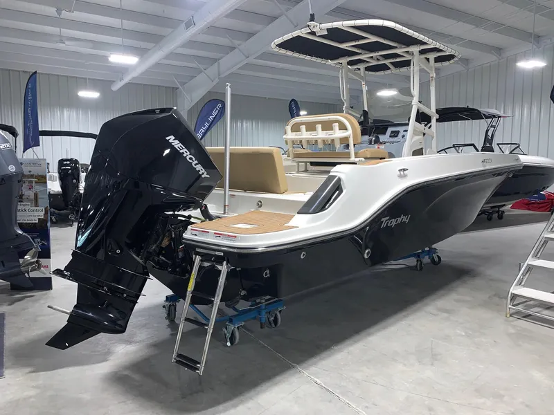 Slide: The Image of 2024 Bayliner Trophy 22CC boat with Mercury outboard motor in showroom. - 2