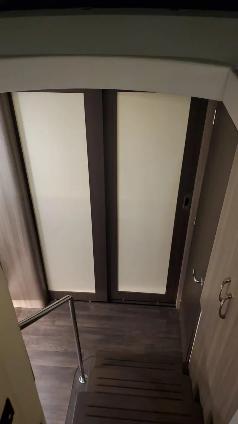 Slide: The Image of Interior stairs of a 2022 Regal 42 XO yacht with modern sliding doors. - 10