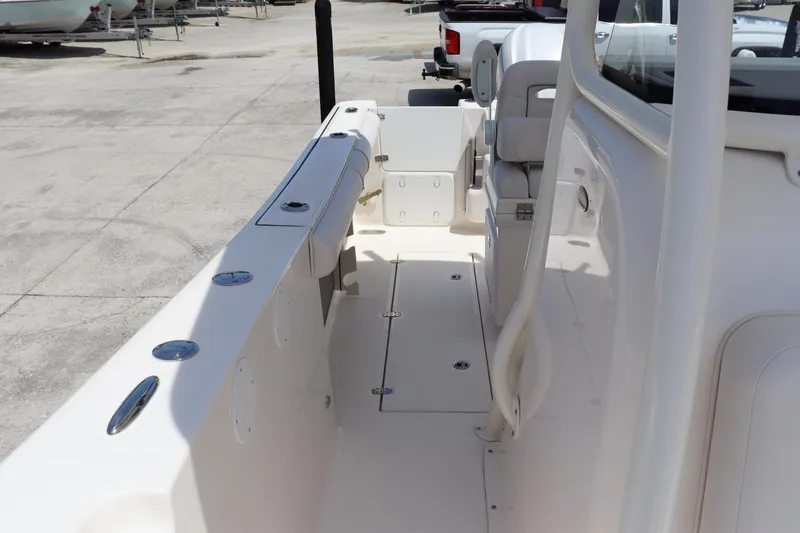 Slide: The Image of 2023 Sea Born SX239 Offshore boat interior, spacious deck with seating and storage compartments. - 12