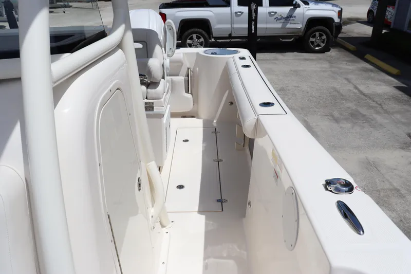 Slide: The Image of 2023 Sea Born SX239 Offshore boat interior, featuring spacious deck and seating area. - 13