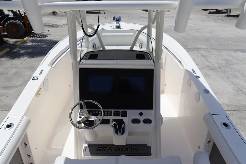 Slide: The Image of 2023 Sea Born SX239 Offshore boat cockpit with steering wheel and control panel. - 15