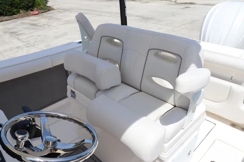 Slide: The Image of 2023 Sea Born SX239 Offshore boat with plush seating and modern steering wheel. - 18