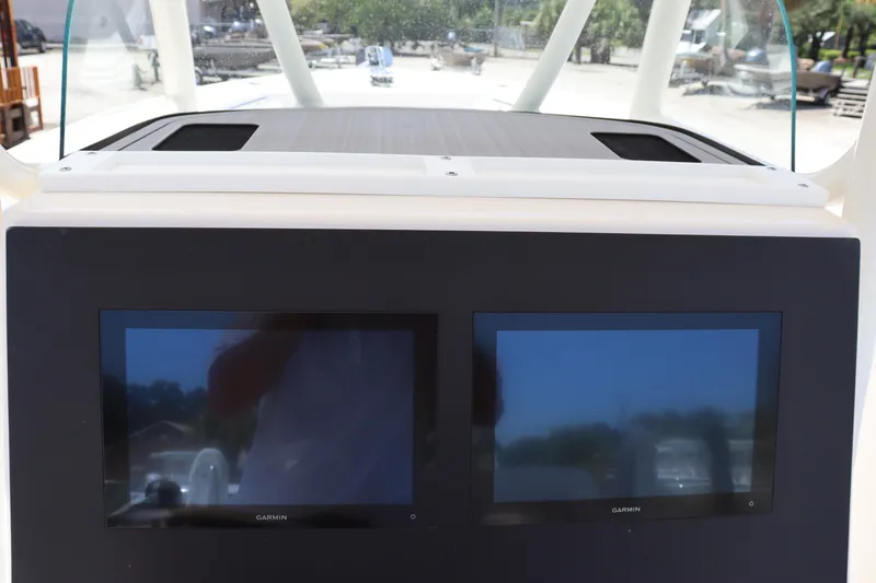 Slide: The Image of 2023 Sea Born SX239 Offshore boat dashboard with dual Garmin displays. - 19