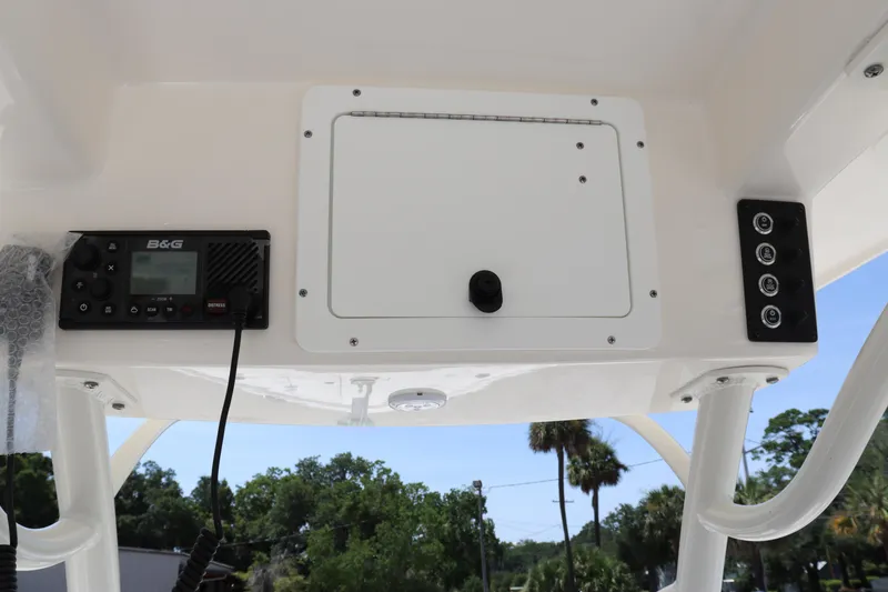 Slide: The Image of 2023 Sea Born SX239 Offshore boat console with electronic controls and storage compartment. - 23