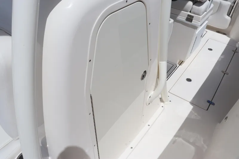 Slide: The Image of 2023 Sea Born SX239 Offshore boat interior detail with white storage compartment. - 29