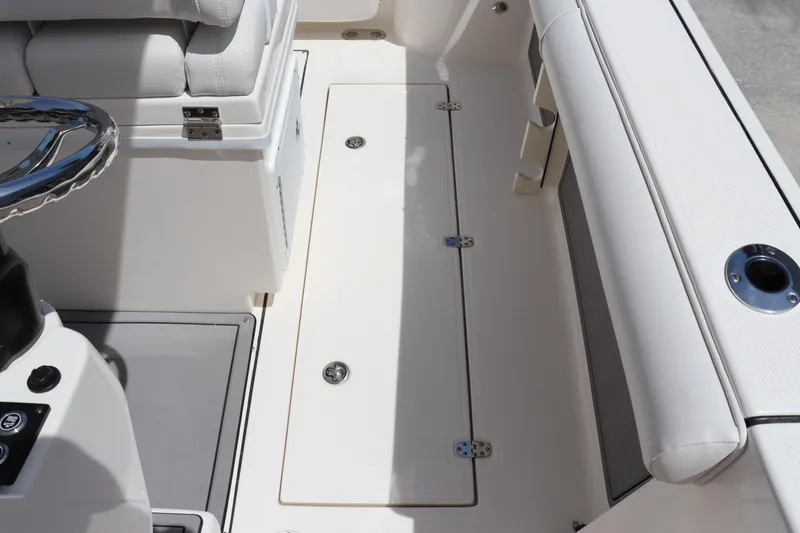 Slide: The Image of 2023 Sea Born SX239 Offshore boat interior with storage compartment and seating. - 37