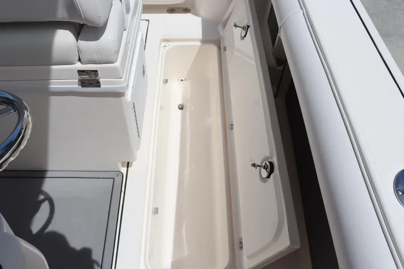 Slide: The Image of 2023 Sea Born SX239 Offshore boat storage compartment with white cushioned seating. - 38