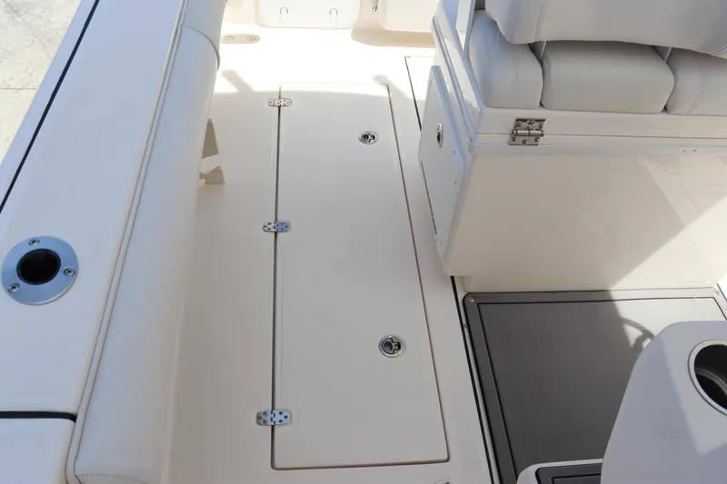 Slide: The Image of 2023 Sea Born SX239 Offshore boat interior, featuring seating and storage compartments. - 39