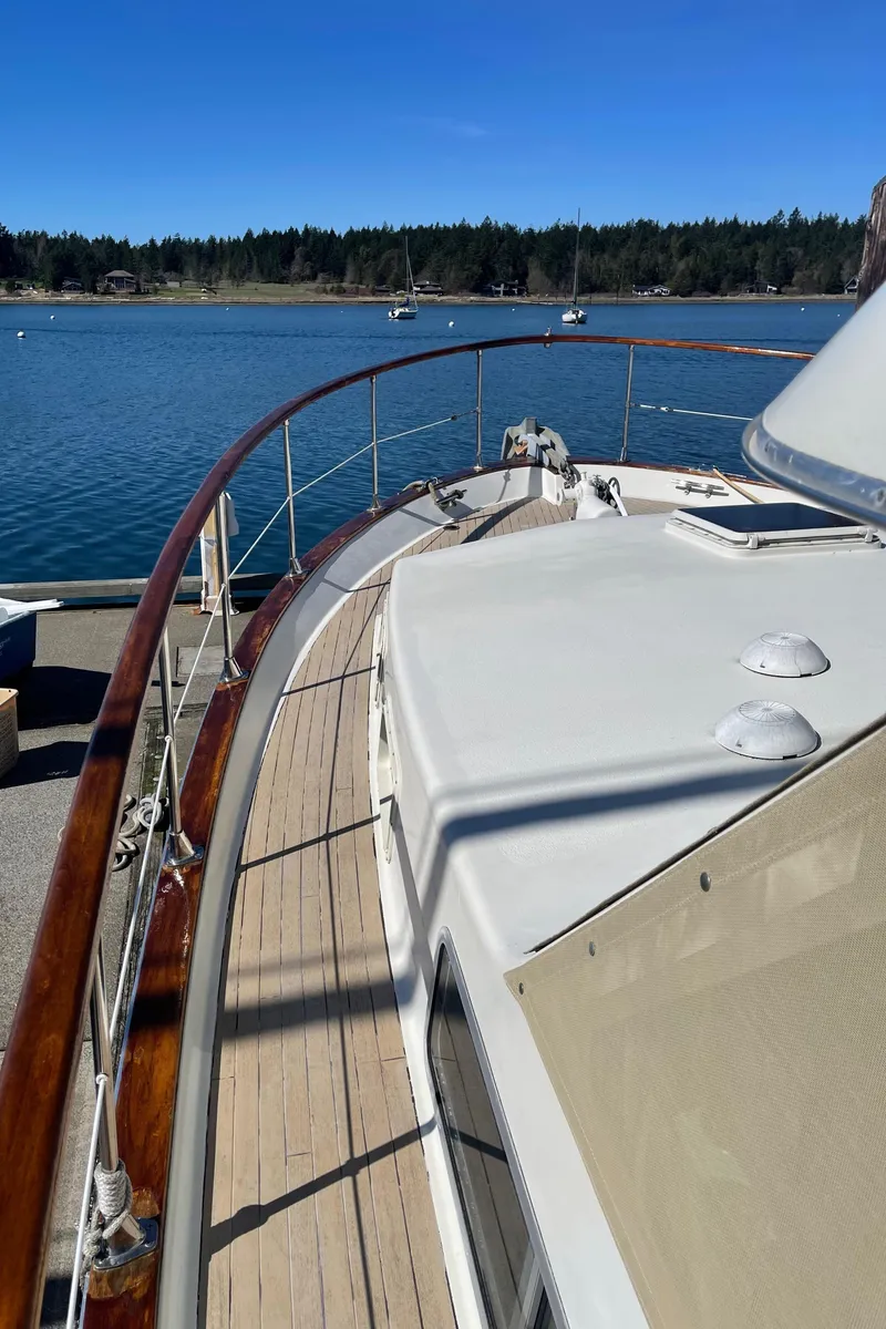 Slide: The Image of 1981 Tollycraft 48 Motor Yacht deck with scenic water view. - 11