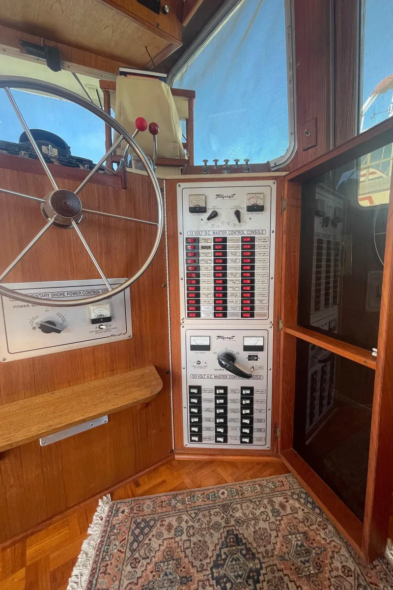 Slide: The Image of 1981 Tollycraft 48 Motor Yacht helm with control panel and steering wheel. - 14