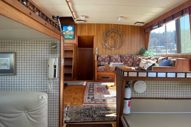 Slide: The Image of Interior of 1981 Tollycraft 48 Motor Yacht with cozy seating and wooden decor. - 17