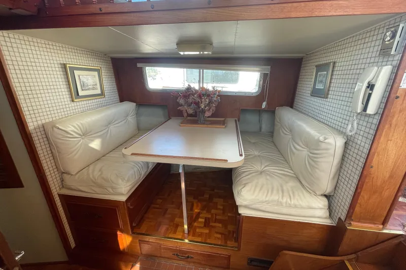 Slide: The Image of 1981 Tollycraft 48 Motor Yacht interior dining area with cushioned seating and table. - 20