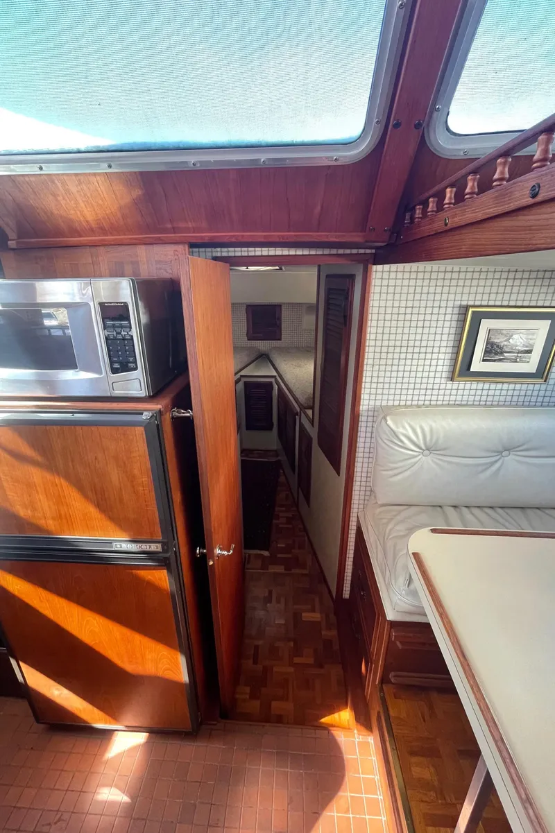 Slide: The Image of Interior of 1981 Tollycraft 48 Motor Yacht with wood finishes and natural light. - 21