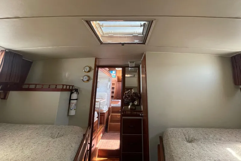 Slide: The Image of 1981 Tollycraft 48 Motor Yacht interior cabin with twin beds and skylight. - 23
