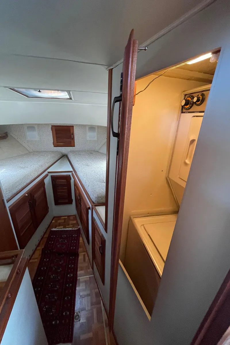Slide: The Image of Interior of 1981 Tollycraft 48 Motor Yacht with laundry area and cozy cabin. - 24