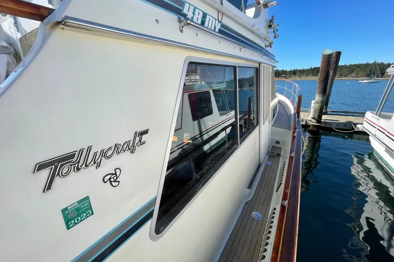 Slide: The Image of 1981 Tollycraft 48 Motor Yacht docked at a marina. - 3