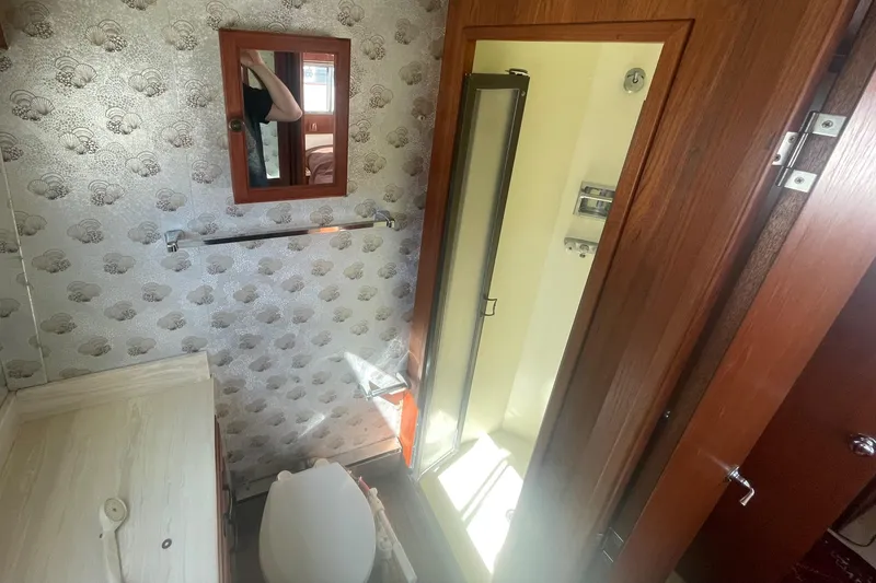 Slide: The Image of 1981 Tollycraft 48 Motor Yacht bathroom with shower, toilet, and vanity. - 30