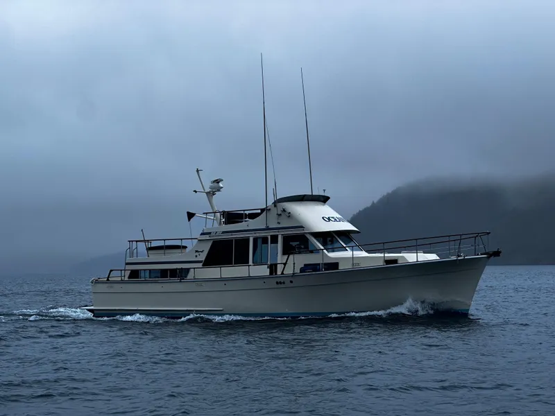 Slide: The Image of 1981 Tollycraft 48 Motor Yacht cruising on a misty, overcast day. - 32