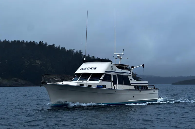 Slide: The Image of 1981 Tollycraft 48 Motor Yacht cruising on a misty lake. - 34