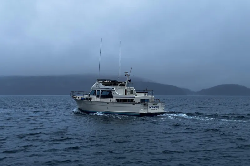 Slide: The Image of 1981 Tollycraft 48 Motor Yacht cruising on a misty lake. - 35