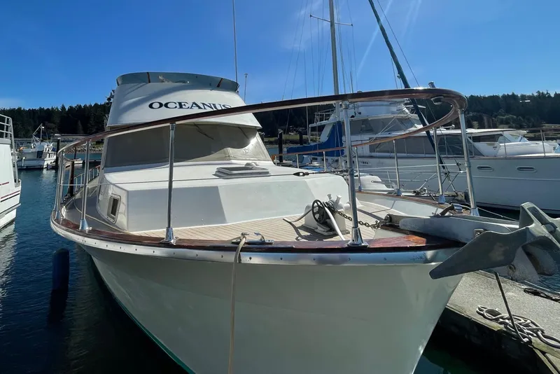 Slide: The Image of 1981 Tollycraft 48 Motor Yacht docked in a marina on a sunny day. - 4
