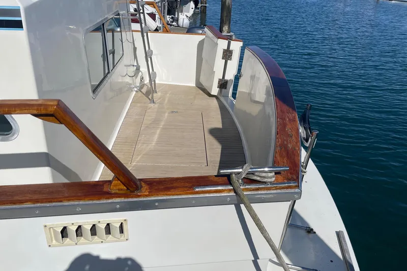 Slide: The Image of 1981 Tollycraft 48 Motor Yacht deck with wooden railings and ocean view. - 9