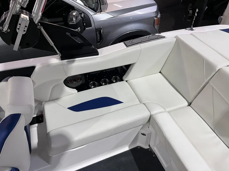 Slide: The Image of 2023 MasterCraft NXT21 boat interior with white and blue seating, showcasing modern design. - 10