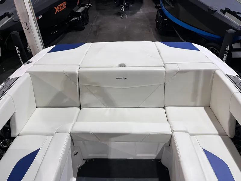 Slide: The Image of 2023 MasterCraft NXT21 boat interior with white and blue seating. - 13