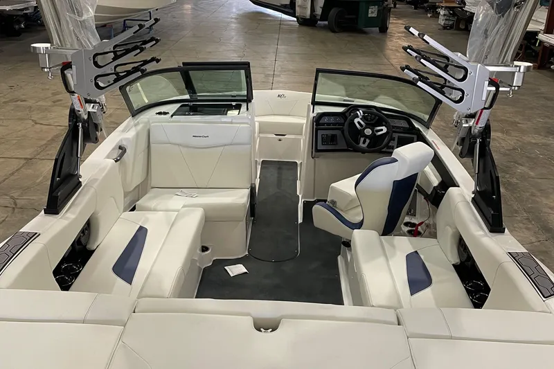 Slide: The Image of 2023 MasterCraft NXT21 boat interior with white seating and modern dashboard. - 7