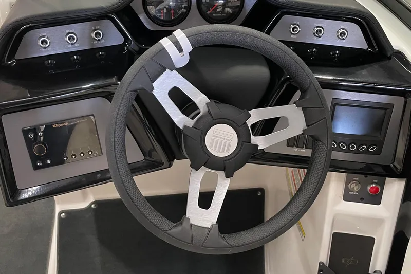 Slide: The Image of 2023 MasterCraft NXT21 boat dashboard with modern steering wheel and control panels. - 8