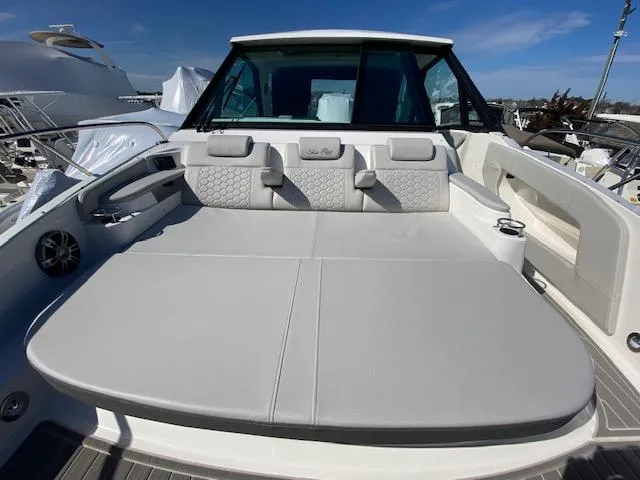 Slide: The Image of 2024 Sea Ray Sundancer 320 OB boat with spacious sunpad and luxurious seating. - 3