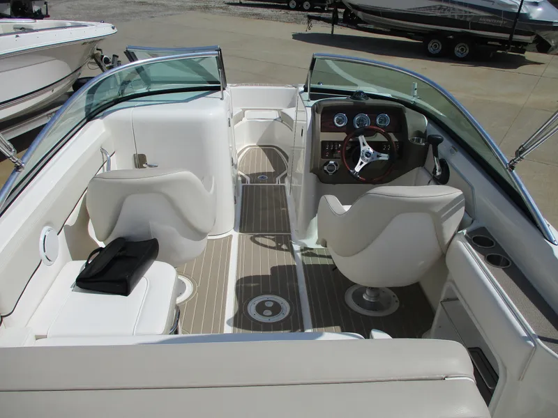 Slide: The Image of Interior view of a 2012 Sea Ray 220 Sundeck boat with sleek seating. - 2