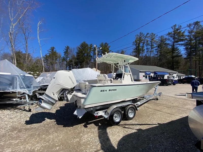Slide: The Image of 2023 Sea Born LX 22 LE boat on trailer in outdoor dealership lot. - 2