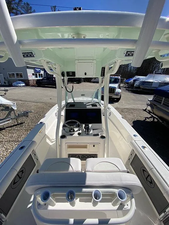 Slide: The Image of 2023 Sea Born LX 22 LE boat interior with helm and seating area. - 4