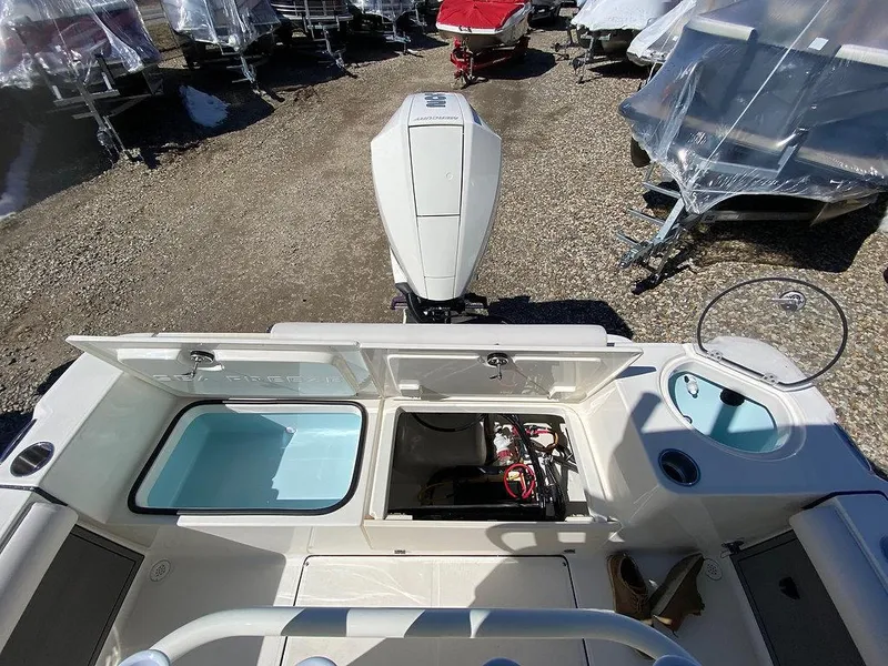 Slide: The Image of 2023 Sea Born LX 22 LE boat interior with storage compartments and engine view. - 9