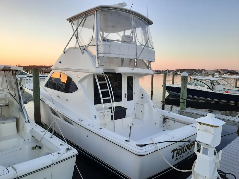 Slide: The Image of 2008 Tiara Yachts 3900 Convertible docked at sunset. - 10