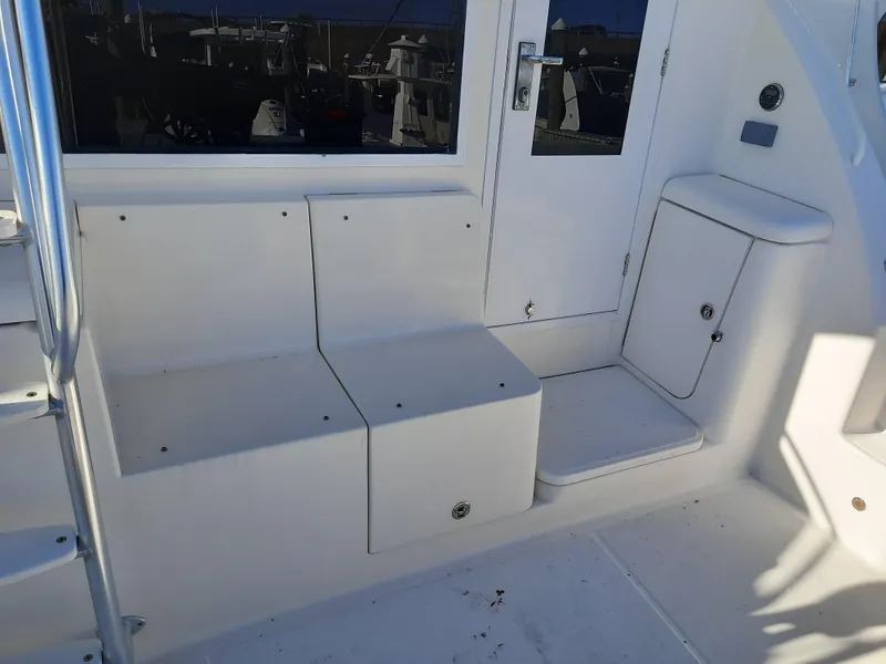 Slide: The Image of 2008 Tiara Yachts 3900 Convertible boat seating and storage area. - 12