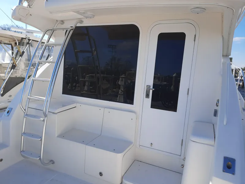 Slide: The Image of 2008 Tiara Yachts 3900 Convertible rear deck with ladder and seating. - 13